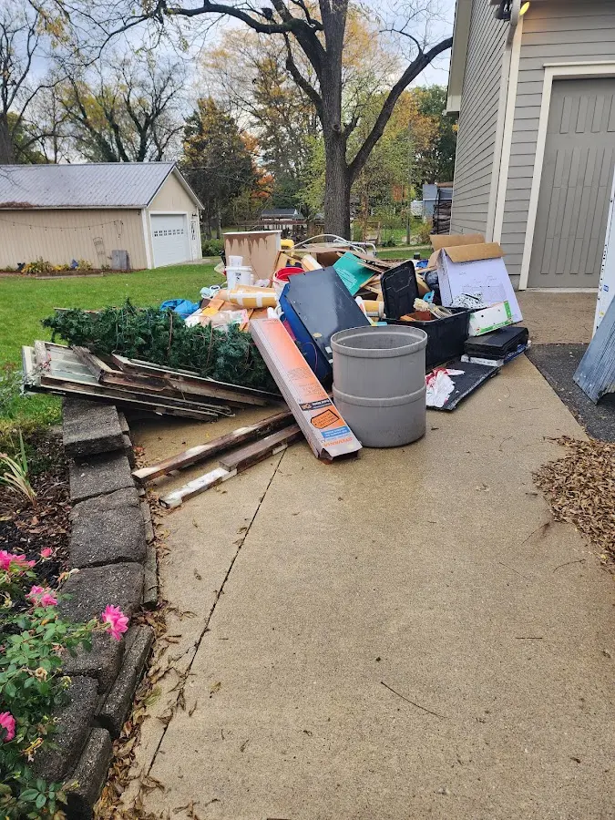 Dumpster being loaded with debris for 12 Yard Dumpster Rental in Cornville